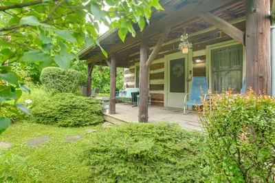 a porch of a house with a blue chair at 3 Mi to River 11-Acre Retreat in Rural Stockport in Chesterhill