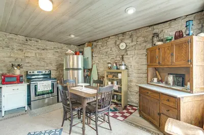 a kitchen with a table and a stove and a refrigerator at 3 Mi to River 11-Acre Retreat in Rural Stockport in Chesterhill