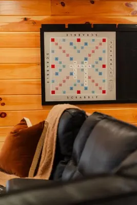 a tablet hanging on a wall next to a leather chair at Sleeps 16 Luxury Cabin with Game Room & Hot Tub in Logan