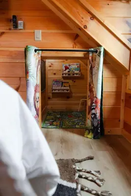 a small room in a bedroom with an attic at Sleeps 16 Luxury Cabin with Game Room & Hot Tub in Logan
