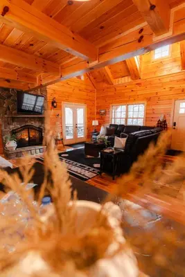 a living room with a couch and a fireplace at Sleeps 16 Luxury Cabin with Game Room & Hot Tub in Logan