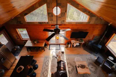 an overhead view of a living room with a ceiling fan at COZY Cabin with Hot Tub - Near all in Hocking Hills in Logan