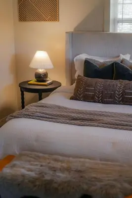 a bedroom with two beds and a table with a lamp at COZY Cabin with Hot Tub - Near all in Hocking Hills in Logan