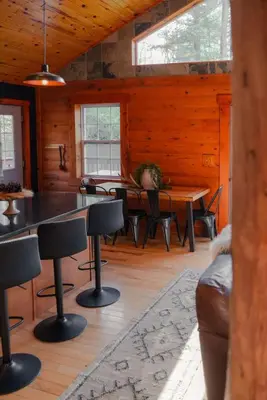 a dining room with a table and chairs in a cabin at COZY Cabin with Hot Tub - Near all in Hocking Hills in Logan