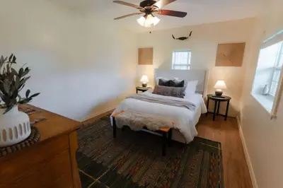 a bedroom with a bed and a ceiling fan at COZY Cabin with Hot Tub - Near all in Hocking Hills in Logan
