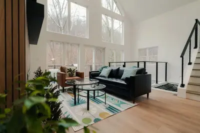 a living room with a couch and a table at The Greenhouse with Indoor Slide close to Hocking Hills in South Bloomingville