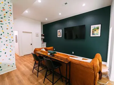 a living room with a couch and a table with chairs at The Greenhouse with Indoor Slide close to Hocking Hills in South Bloomingville