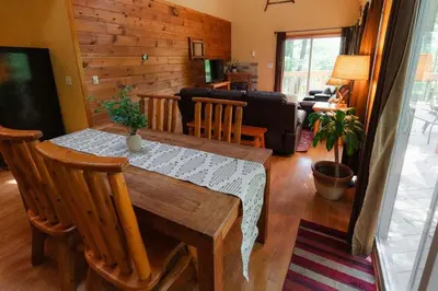 a living room with a table and a couch at Cheerful Two Bdrm Cabin with Hot Tub & Pet Friendly in Rockbridge