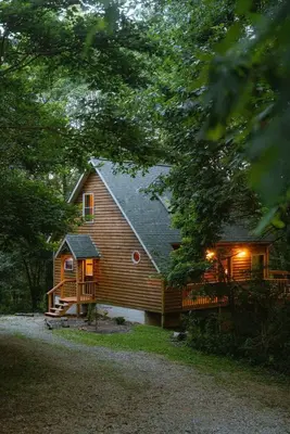 a log cabin with a porch and a deck at Cheerful Two Bdrm Cabin with Hot Tub & Pet Friendly in Rockbridge