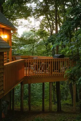 a wooden deck with chairs on it in the woods at Cheerful Two Bdrm Cabin with Hot Tub & Pet Friendly in Rockbridge