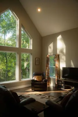 a living room with two large windows and a couch at Modern 2 BD cabin with hot tub & Games & Central Loc in Rockbridge