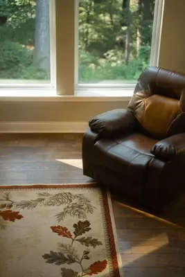 a leather couch in a living room with a window at Modern 2 BD cabin with hot tub & Games & Central Loc in Rockbridge