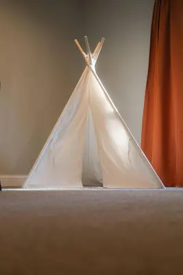 a white teepee tent sitting on the floor at Modern 2 BD cabin with hot tub & Games & Central Loc in Rockbridge