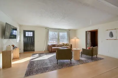 a living room with a couch and a table and chairs at Buckingham Woods I Hocking Hills in Logan