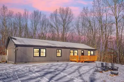 a house with a garage in the snow at Buckingham Woods I Hocking Hills in Logan