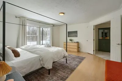 a bedroom with a large bed and a large mirror at Buckingham Woods I Hocking Hills in Logan