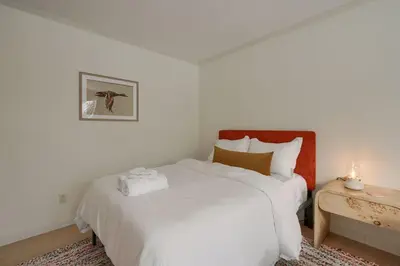 a bedroom with a white bed and a side table at Buckingham Woods I Hocking Hills in Logan