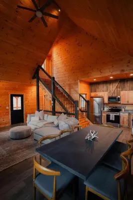 a large living room with a table and chairs at Memories at Hillside A Modern Cabin Hocking Hills in McArthur