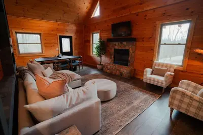 a living room with a couch and a fireplace at Memories at Hillside A Modern Cabin Hocking Hills in McArthur
