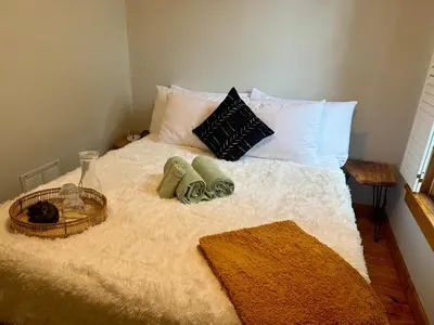 a bed with two pillows and a basket on it at Jungle House Luxury Stays - Columbus Downtown Short North in Columbus