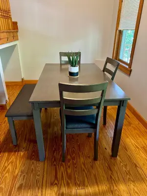 a table with two chairs and a potted plant on it at Jungle House Luxury Stays - Columbus Downtown Short North in Columbus