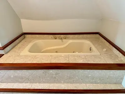 a bath tub in the corner of a bathroom at Jungle House Luxury Stays - Columbus Downtown Short North in Columbus