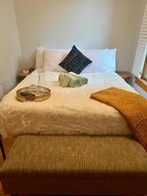 a large bed with a basket on top of it at Jungle House Luxury Stays - Columbus Downtown Short North in Columbus