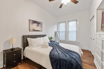 a bedroom with a bed and a ceiling fan at Entire Duplex - 2 Units in Columbus
