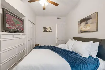 a bedroom with a bed with a tv on it at Entire Duplex - 2 Units in Columbus