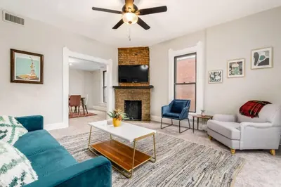 a living room with a couch and a fireplace at Entire Duplex - 2 Units in Columbus