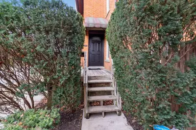 a stairway leading to a house with a black door at Entire Duplex - 2 Units in Columbus