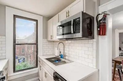 a kitchen with a sink and a microwave at Entire Duplex - 2 Units in Columbus
