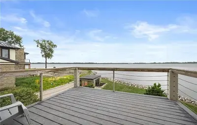 a wooden deck with a view of the water at Waterfront Luxury Family Retreat in Sandusky