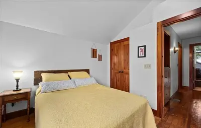 a bedroom with a bed and a table with a lamp at Waterfront Luxury Family Retreat in Sandusky