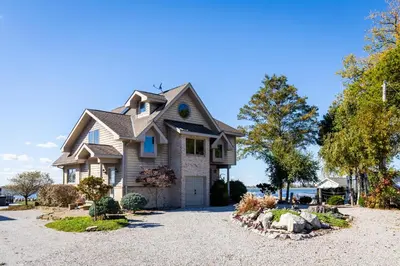 a house with a landscaping in the driveway at Waterfront Luxury Family Retreat in Sandusky