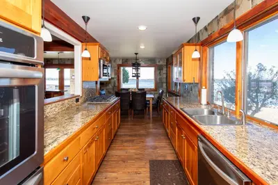 a kitchen with wooden cabinets and a sink at Waterfront Luxury Family Retreat in Sandusky