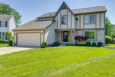 a house with a green lawn in front of it at Families Welcome Lake-View Home, 2 Mi to Gahanna! in Columbus