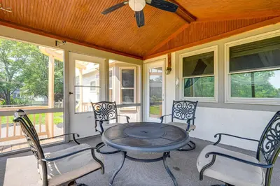 a screened in porch with a table and chairs at Families Welcome Lake-View Home, 2 Mi to Gahanna! in Columbus