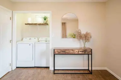 a kitchen with a washer and dryer and a table at The Estate on 68 AND Pet Friendly in Springfield