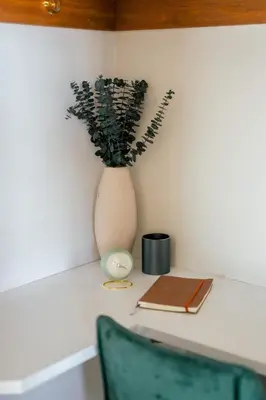 a vase with a plant and a book on a desk at The Estate on 68 AND Pet Friendly in Springfield