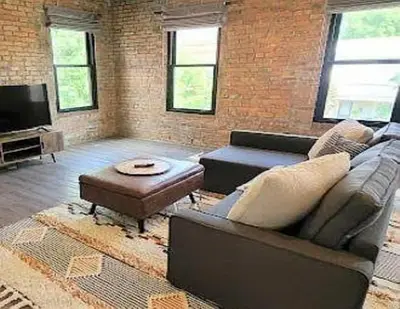 a living room with a couch and a coffee table at Jungle House Columbus Downtown Free Parking Sleeps 8 - Steps to Convention Center & Nationwide Arena - 2BR Short North Luxury Home - Over 5,800 Five Star Stays in Columbus