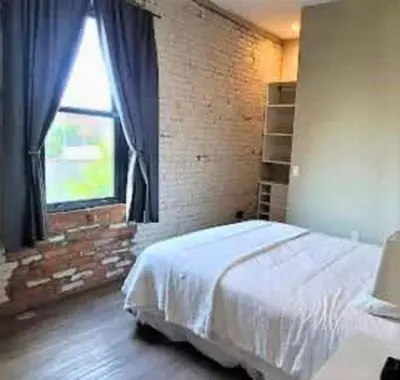 a bedroom with a large bed and a window at Jungle House Columbus Downtown Free Parking Sleeps 8 - Steps to Convention Center & Nationwide Arena - 2BR Short North Luxury Home - Over 5,800 Five Star Stays in Columbus