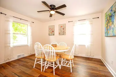 a dining room with a table and chairs and a ceiling fan at South Euclid 4BR Luxe Escape with Game room and BBQ in South Euclid