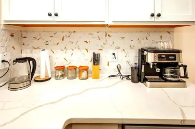 a kitchen counter with a toaster and a coffee maker at South Euclid 4BR Luxe Escape with Game room and BBQ in South Euclid