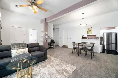 a living room with a couch and a table at Collins Avenue Duplex – 2 Homes in Columbus