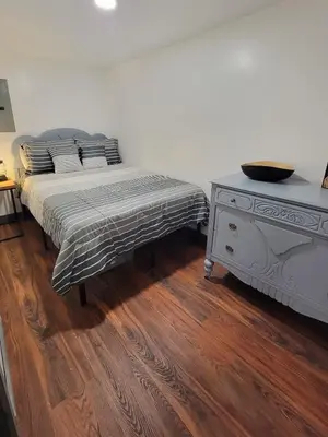 a bedroom with a bed and a dresser with a bowl on it at Boons Camp Cabin