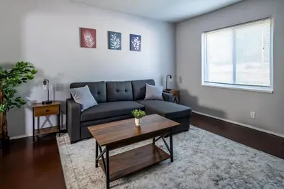 a living room with a couch and a coffee table at Cozy 2BR Retreat with Workspace - Washer and Dryer in Kettering