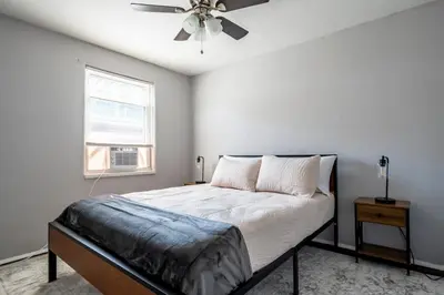 a bedroom with a bed and a ceiling fan at Cozy 2BR Retreat with Workspace - Washer and Dryer in Kettering