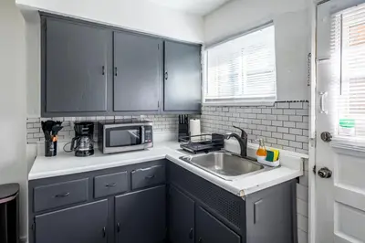 a kitchen with a sink and a microwave at Cozy 2BR Retreat with Workspace - Washer and Dryer in Kettering