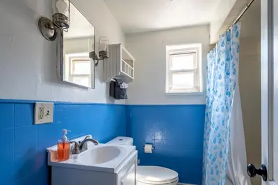 a blue bathroom with a toilet and a sink at Cozy 2BR Retreat with Workspace - Washer and Dryer in Kettering